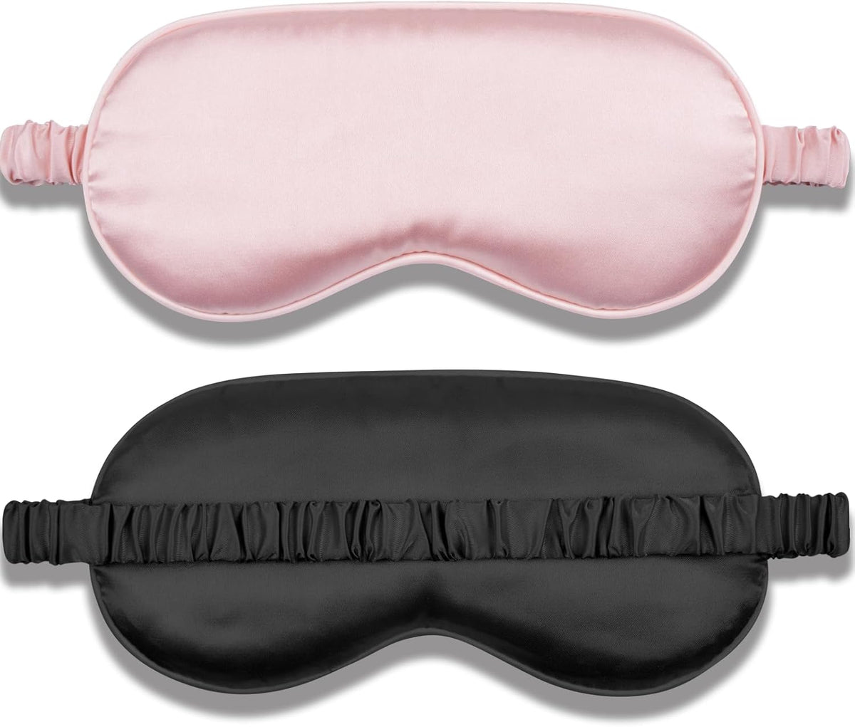 Set of two silk sleep masks in pink and black with adjustable straps, soft eye shades for blocking light and reducing puffiness.