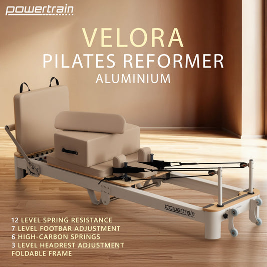 Powertrain Velora beige aluminium foldable Pilates reformer with multifunctional core exercise features and adjustable footbar for full-body workouts.