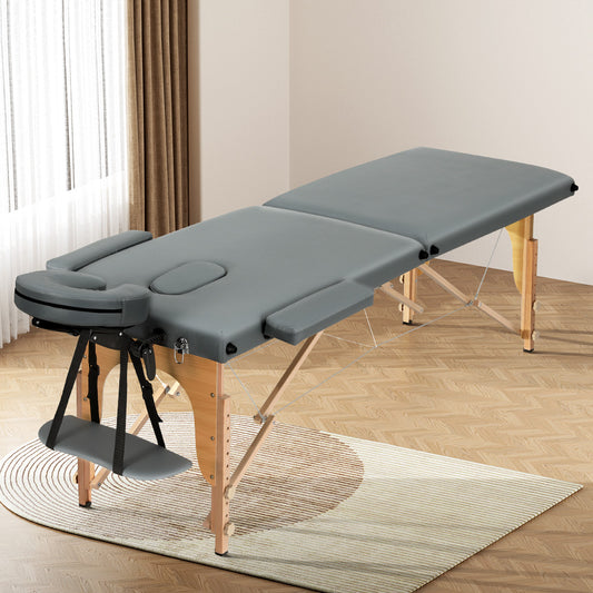 Grey portable Zenses massage table with 2-fold wooden frame, 56cm width, designed for relaxation and beauty treatments.