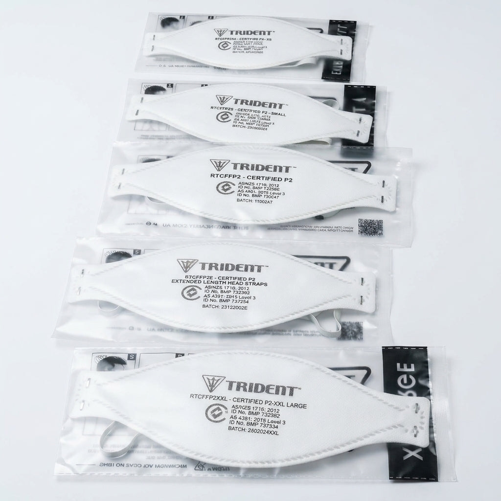 Multiple packages of Trident branded face masks on a white background