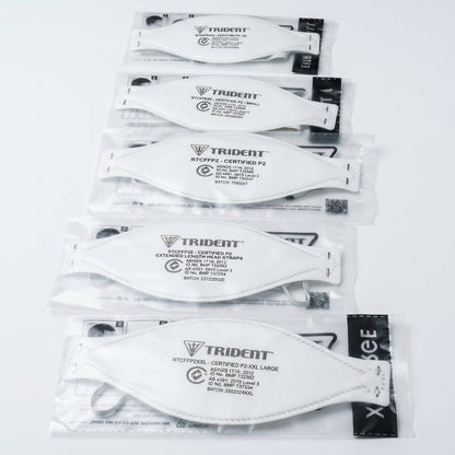 Multiple packages of Trident branded face masks on a white background