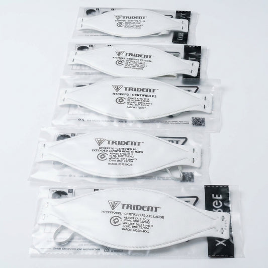 Multiple packages of Trident branded face masks on a white background