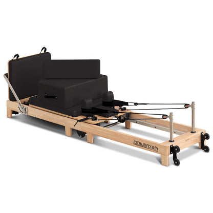 Hlpmedical Powertrain Selina Pilates Reformer Machine in oak and black with wooden frame, jumpboard, and sitting box for home gym fitness