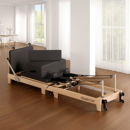 Hlpmedical Powertrain Selina Pilates Reformer Machine in black wood with jumpboard and sitting box, ideal for home yoga and Pilates workouts.