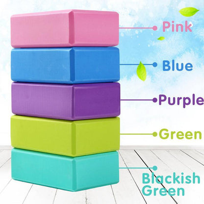 Two purple foam yoga blocks for fitness and Pilates exercises, used for stretching and support during yoga practice.