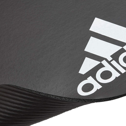 Grey Adidas fitness mat for yoga, Pilates, and exercise, featuring 7mm thickness for comfortable gym and training workouts.