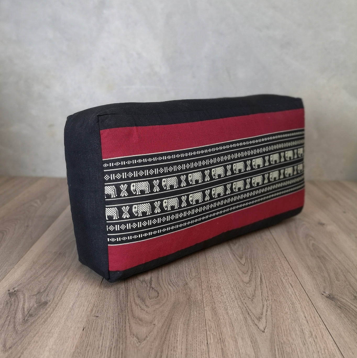 RedEle brand oblong meditation cushion filled with kapok, used for yoga and wellness practices, in vibrant red color.