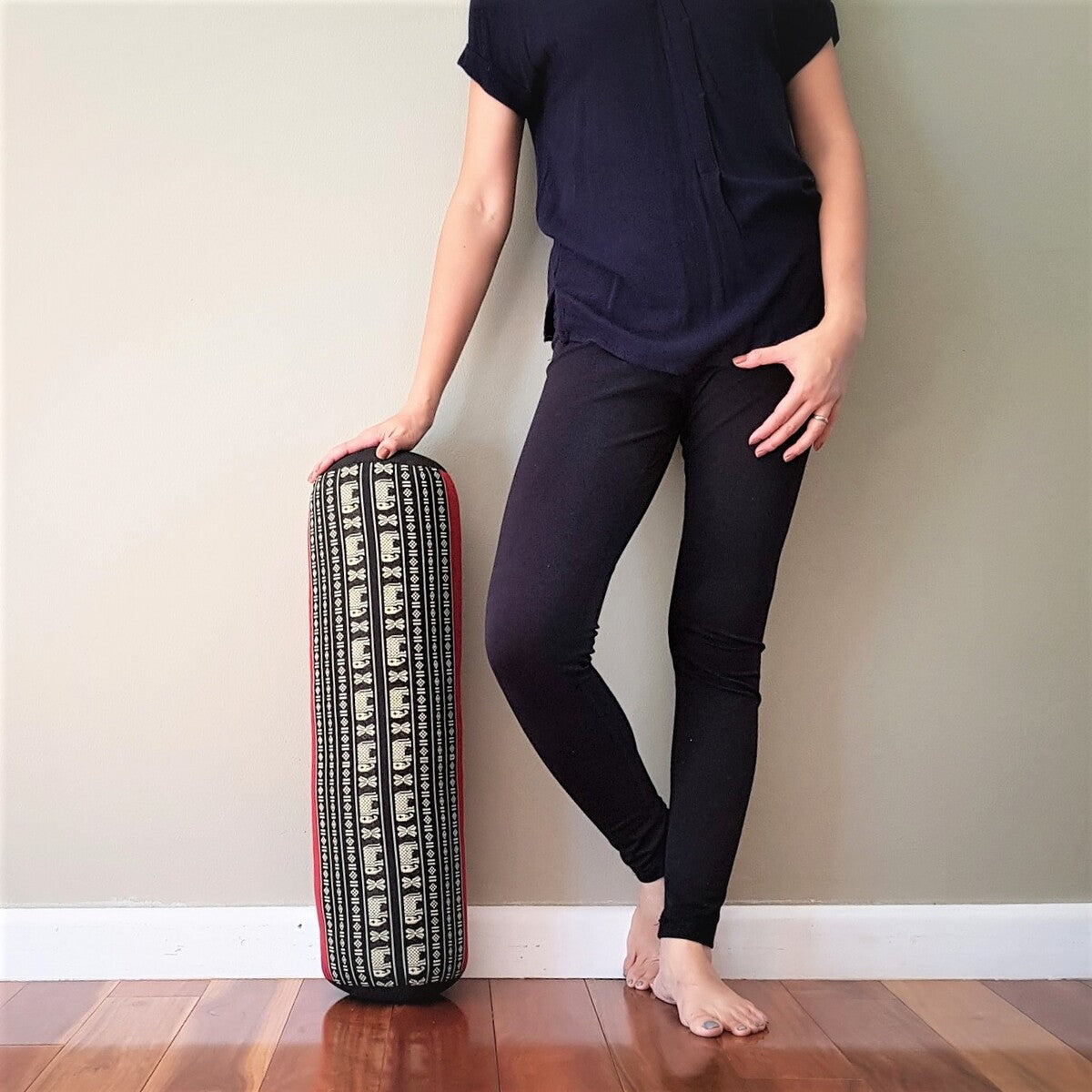 RedEle yoga bolster filled with natural kapok, designed for wellness and relaxation, shown with its vibrant red cover.