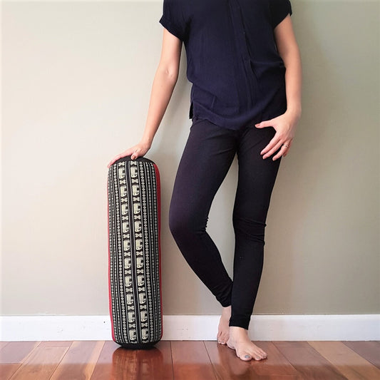 RedEle yoga bolster filled with natural kapok, designed for wellness and relaxation, shown with its vibrant red cover.