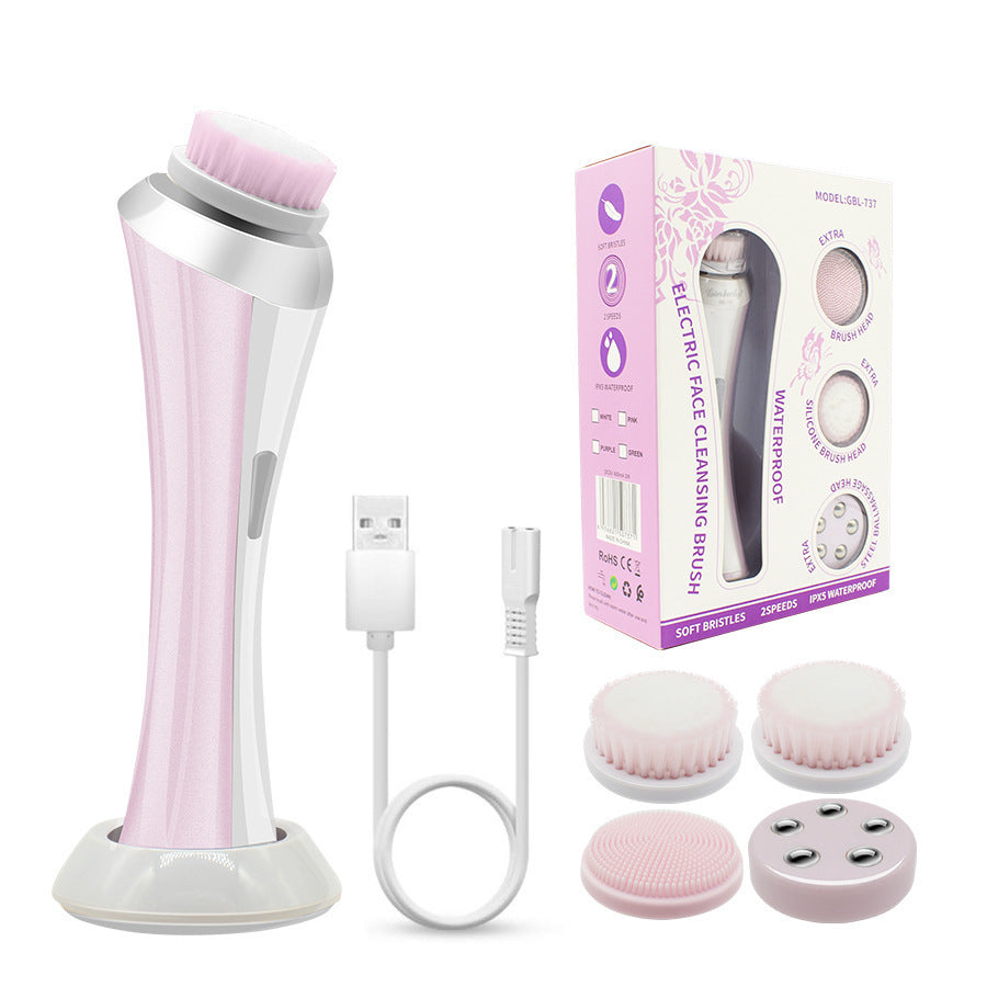Pink rechargeable facial cleansing brush kit with four heads and charging dock, designed for gentle skincare.