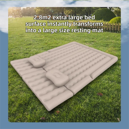 Beige multi-chamber car inflatable air mattress with electric pump, pillows, and storage bag for trunk sleeping and camping.