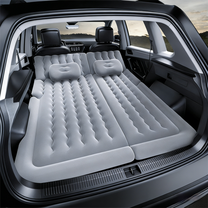 Grey multi-chamber car inflatable air mattress with electric pump, pillows, and storage bag for trunk sleeping and camping.