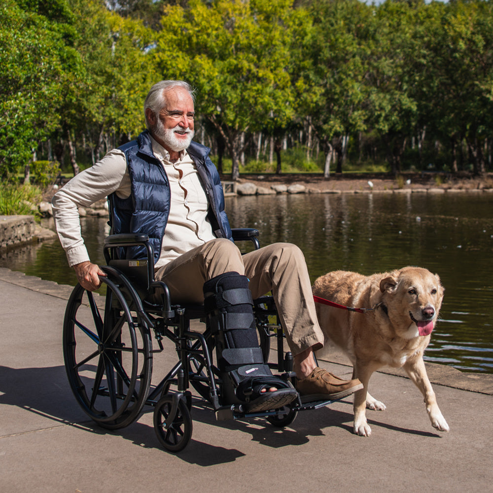 Black EQUIPMED portable folding wheelchair with 24-inch wheels, retractable armrests, suitable for up to 136kg capacity.