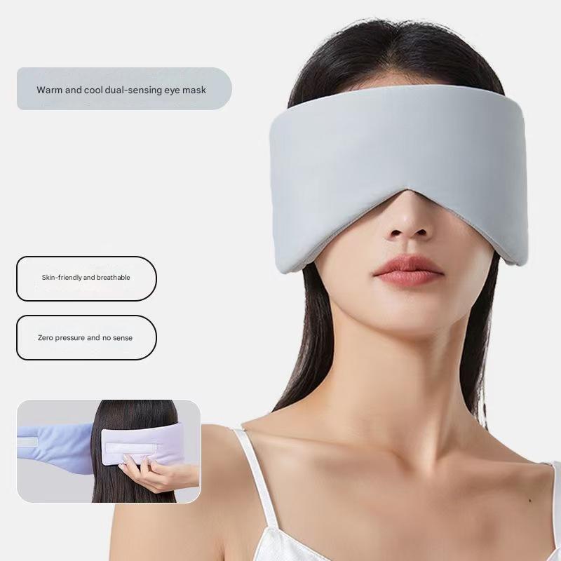 Grey reversible all-season sleep mask by Hlpmedical with cooling, warming, and sound muffling ear covers for restful sleep.