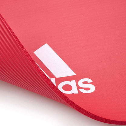 Red Adidas Fitness Mat 7mm for exercise, yoga, judo, and Pilates, ideal for gym and training floor workouts.