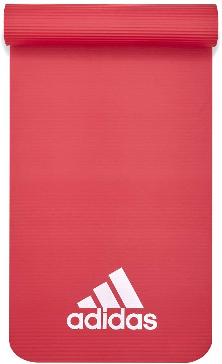 Red Adidas fitness mat 7mm for yoga, pilates, judo, and exercise training, shown rolled out on gym floor.
