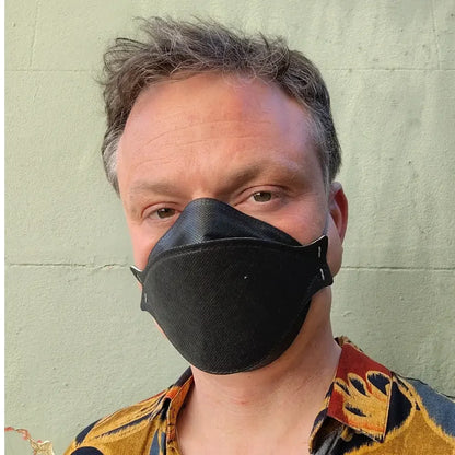 Man wearing Hlpmedical Trident Project 3 FFP3 black face mask respirator, showing the comfortable fit and secure design.